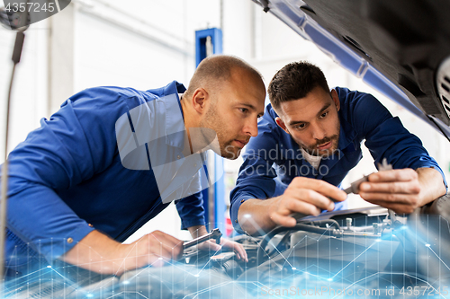 Image of mechanic men with wrench repairing car at workshop