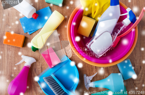 Image of basin with cleaning stuff on wooden floor