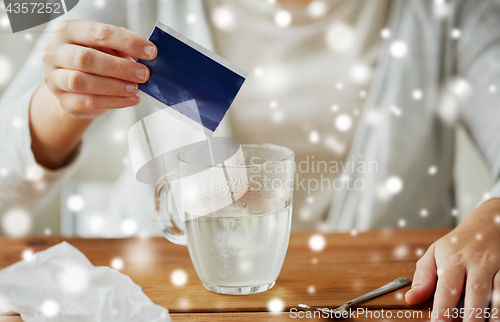 Image of close up of ill woman pouring medication into cup