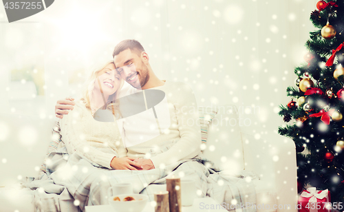 Image of happy couple at home with christmas tree