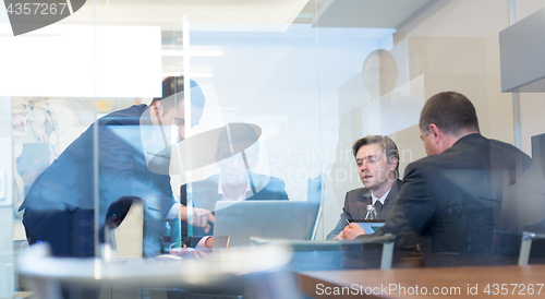 Image of Business people sitting and brainstorming at corporate meeting.