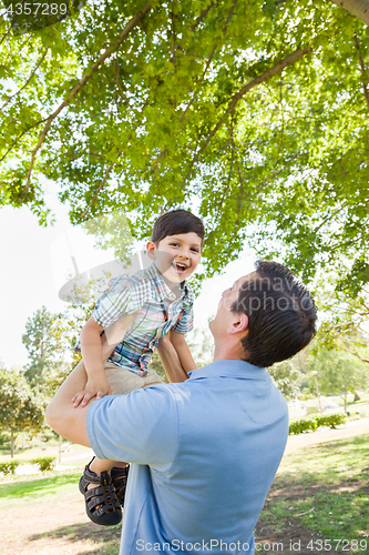 Image of Happy Caucasian Father and Son Playing Together in the Park.