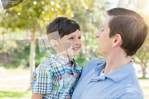 Image of Happy Caucasian Father and Son Playing Together in the Park.