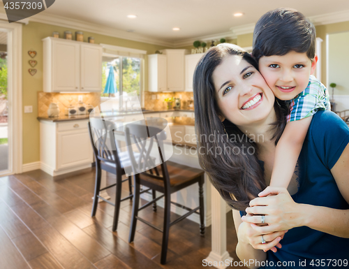 Image of Young Mother and Son Inside Beautiful Custom Kitchen.