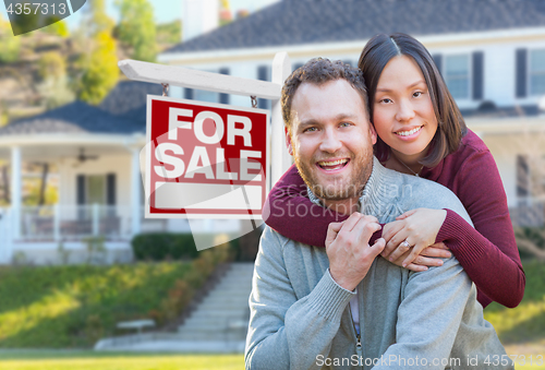 Image of Mixed Race Caucasian and Chinese Couple In Front of For Sale Rea