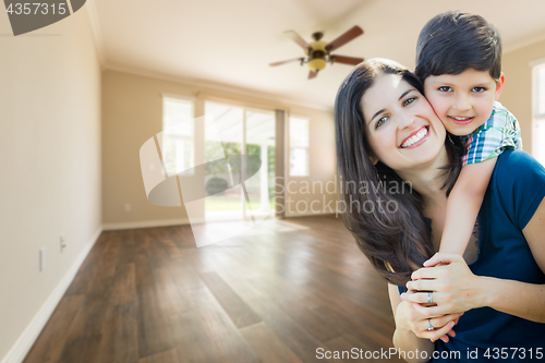 Image of Young Mother and Son Inside Empty Room with Wood Floors.