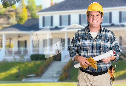 Image of Contractor With Plans and Hard Hat In Front of Beautiful Custom 