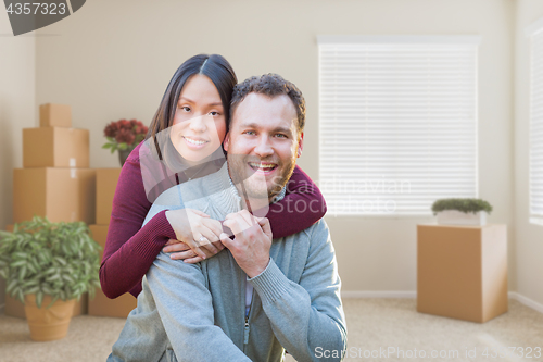 Image of Mixed Race Caucasian and Chinese Couple Inside Empty Room with M