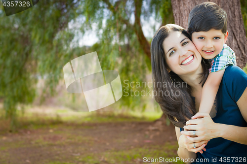 Image of Young Mother and Son Portrait Outdoors.