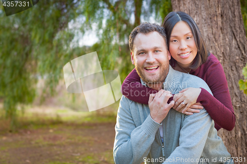 Image of Mixed Race Caucasian and Chinese Couple Portrait Outdoors.
