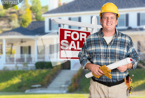 Image of Contractor With Plans and Hard Hat In Front of For Sale Real Est