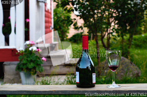 Image of Bottle and a wineglass of wine.