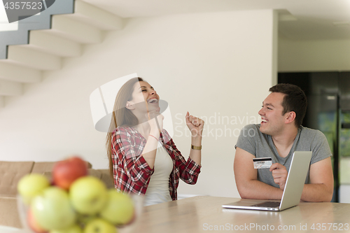 Image of happy young couple buying online