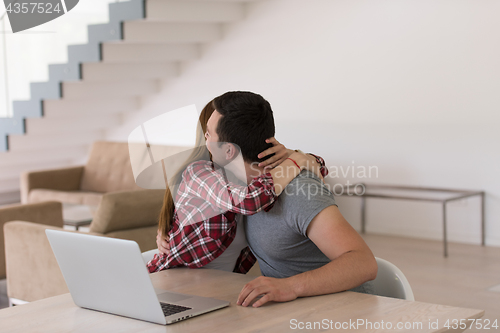 Image of happy young couple buying online