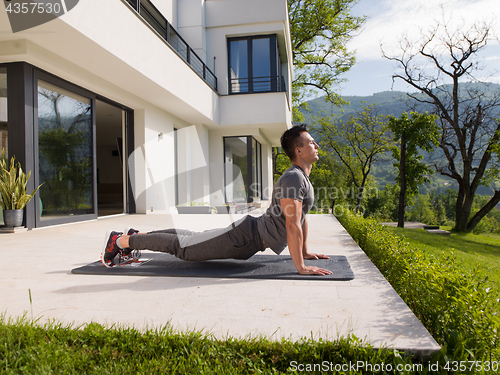 Image of man doing morning yoga exercises