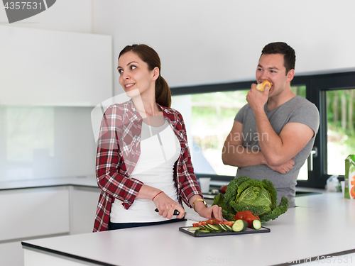 Image of Young handsome couple in the kitchen