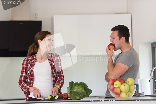 Image of Young handsome couple in the kitchen