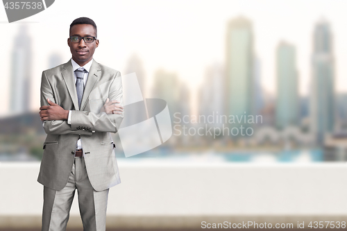 Image of Young black businessman in front of the big city