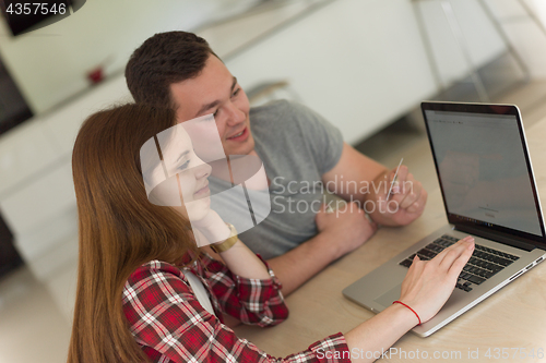 Image of happy young couple buying online