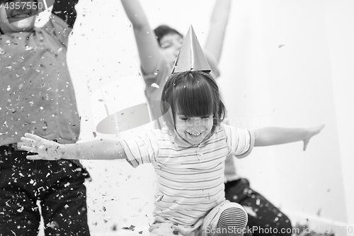 Image of kids  blowing confetti