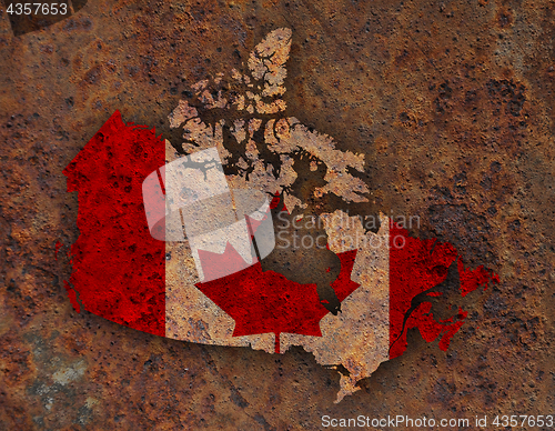 Image of Map and flag of Canada on rusty metal