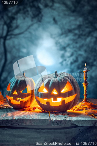 Image of Halloween pumpkins on blue background