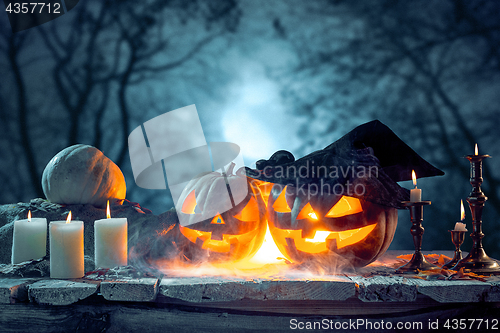 Image of Halloween pumpkins on blue background