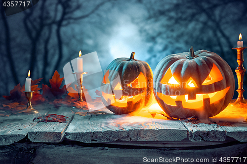 Image of Halloween pumpkins on blue background