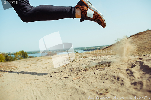 Image of Running sport. Man runner sprinting outdoor in scenic nature. Fit muscular male athlete training trail running for marathon run.