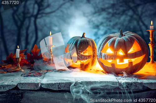 Image of Halloween pumpkins on blue background