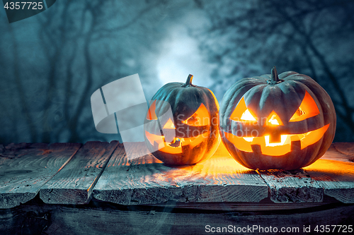 Image of Halloween pumpkins on blue background