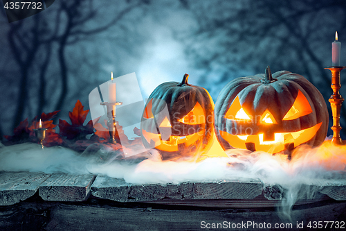 Image of Halloween pumpkins on blue background