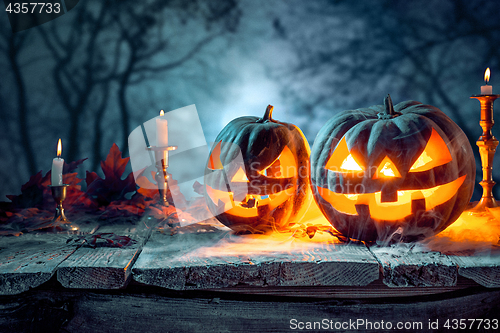 Image of Halloween pumpkins on blue background