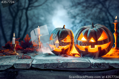 Image of Halloween pumpkins on blue background