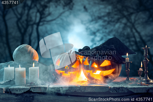 Image of Halloween pumpkins on blue background