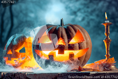 Image of Halloween pumpkins on blue background