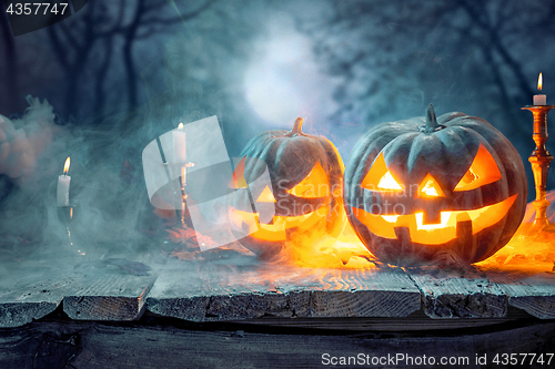 Image of Halloween pumpkins on blue background