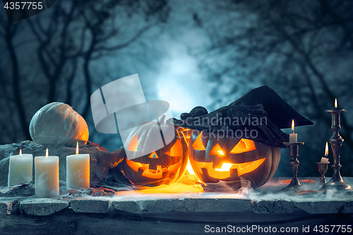 Image of Halloween pumpkins on blue background