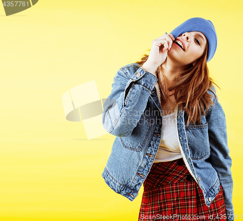 Image of lifestyle people concept: pretty young school teenage girl having fun happy smiling on yellow background