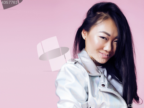 Image of young pretty smiling asian korean girl wearing modern fashion clothers on pink background, lifestyle people concept 