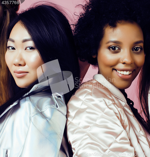 Image of different nation girls with diversuty in skin, hair. Asian, scandinavian, african american cheerful emotional posing on pink background, woman day celebration, lifestyle people concept