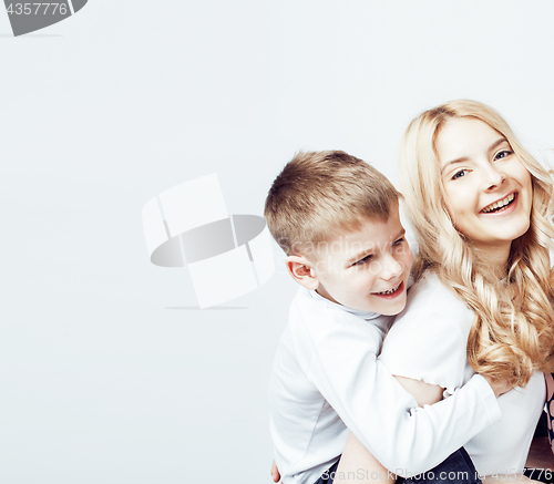 Image of young modern blond curly mother with cute son together happy smiling family posing cheerful on white background, lifestyle people concept, sister and brother friends 