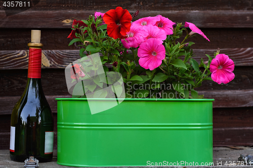 Image of Flowers and a bottle of wine.