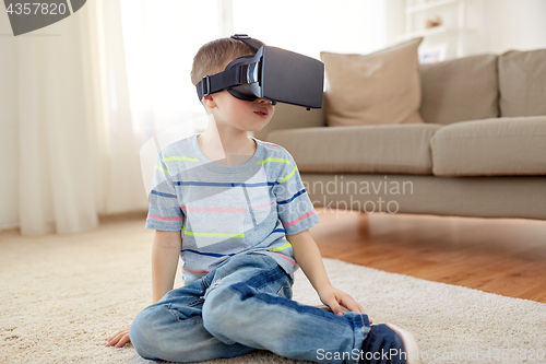 Image of little boy in vr headset or 3d glasses at home