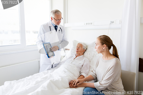 Image of senior woman and doctor with tablet pc at hospital