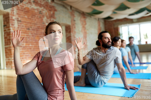 Image of group of people doing yoga at studio