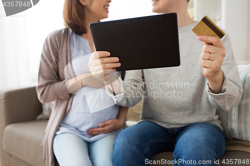 Image of close up of man and pregnant wife shopping online