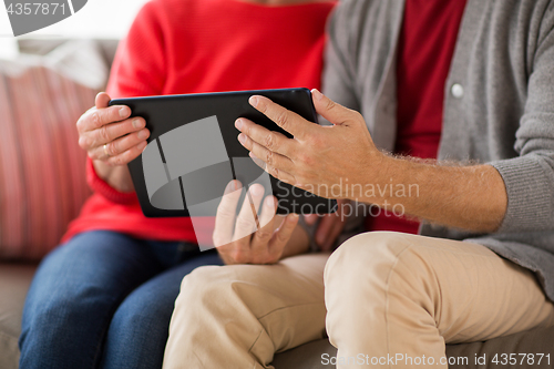Image of close up of senior couple with tablet pc at home