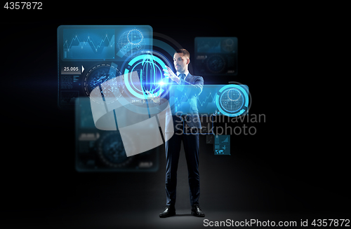 Image of businessman working with charts on virtual screen