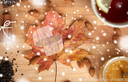 Image of cup of lemon tea and honey on wooden board